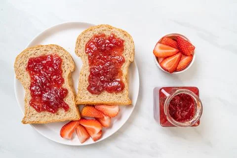 Whole wheat bread with strawberry jam and fresh strawberry Stock Photos