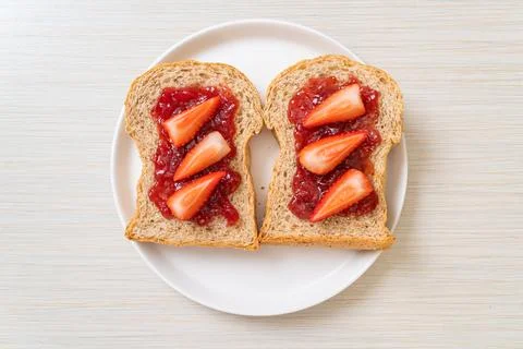 Whole wheat bread with strawberry jam and fresh strawberry Stock Photos