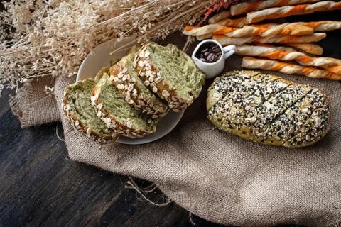 Whole wheat bread,breadstick,jar of coffee beans put on hemp cloth, Stock-Fotos