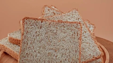 Whole wheat multigrain bread sliced on wooden table. Stock Footage 310846372