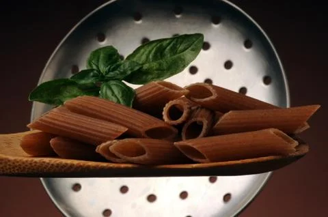 Whole wheat spelled pasta on a spoon Stock Photos