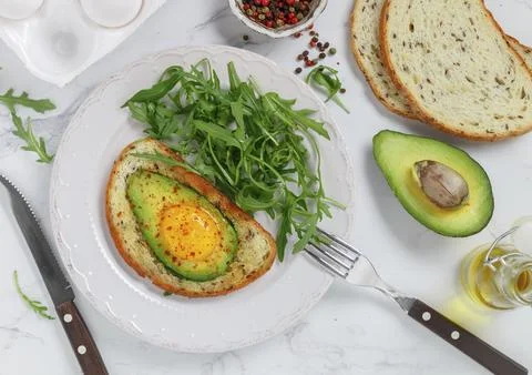 Whole wheat toasted bread with flax seeds with avocado, egg, spices and spices Stock Photos