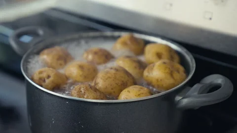 Whole Yellow Potatoes Boiling in a Pot on a Kitchen Stove Stock Footage 341437553