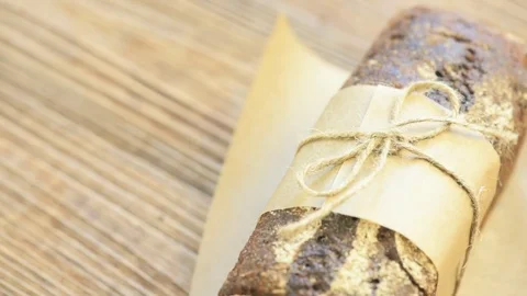 Wholegrain rye bread with twine bow on a wooden board Stock Footage 73051013