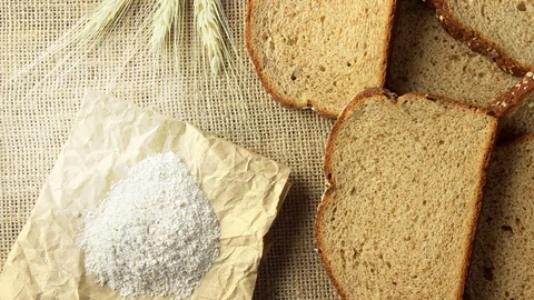 Wholegrain sliced organic bread composed of oats and flax seeds on wooden tab Stock Footage 104580647