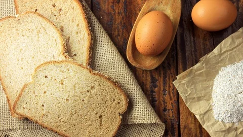 Wholegrain sliced organic bread composed of oats and flax seeds on wooden tab Stock Footage 104580894