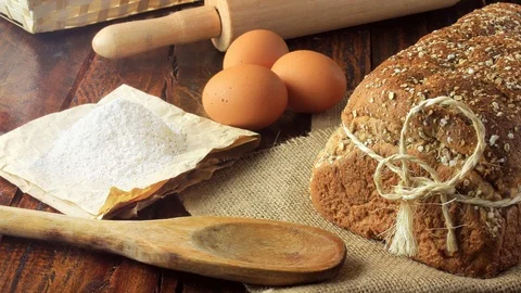 Wholegrain sliced organic bread composed of oats and flax seeds on wooden tab Stock Footage 104580897