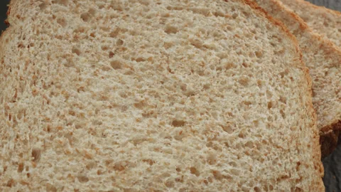 Wholemeal bread macro close up presentation slowly rotating stock footage Stock Footage 344686214