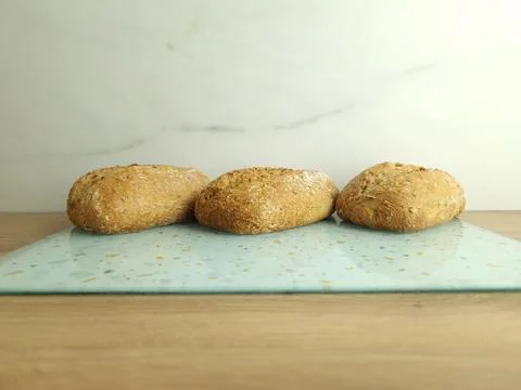 Wholemeal buns on table Stock Photos