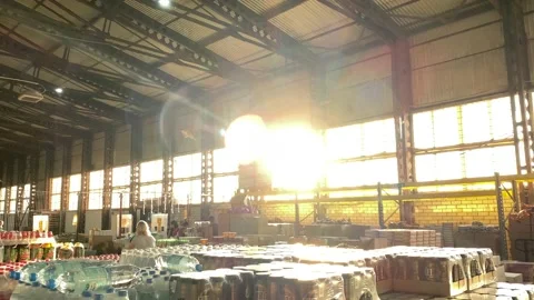 Wholesale store. Sun rays through window. People shopping. Bottles with water Stock Footage 201153059