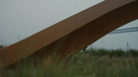 Whoosh past sculpture while looking at smoky Bay Bridge Stock Footage 139656313