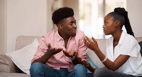 Why are we always arguing. a young couple arguing while sitting on the couch at Stock Photos