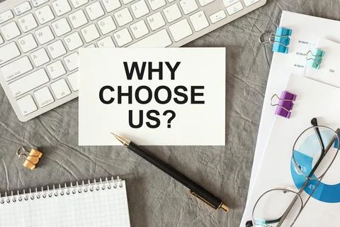Why Choose Us is written in a document on the office desk Stock Photos