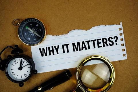 Why It Matters? text on paper torn with compass and magnifying glass on pap.. Foto stock