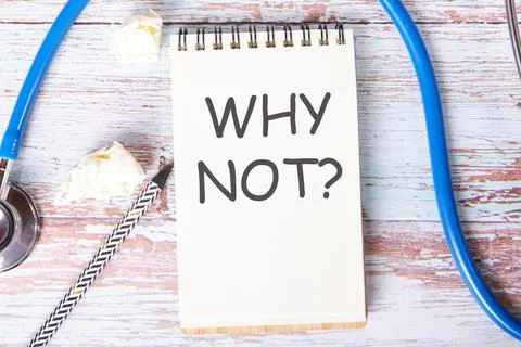 WHY NOT text is written on a notebook that lies on old vintage boards Stock Photos