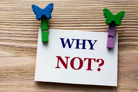 WHY NOT - word on a white sheet with beautiful clothespins on a wooden backgr Stock Photos