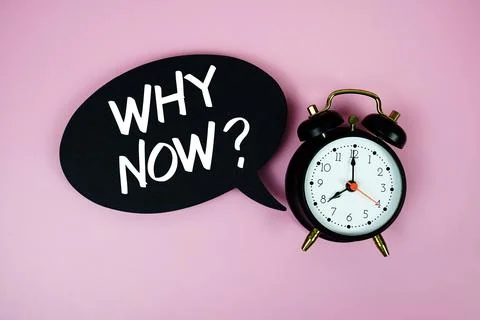 Why Now? text on speech bubble with alarm clock on pink background Stock Photos