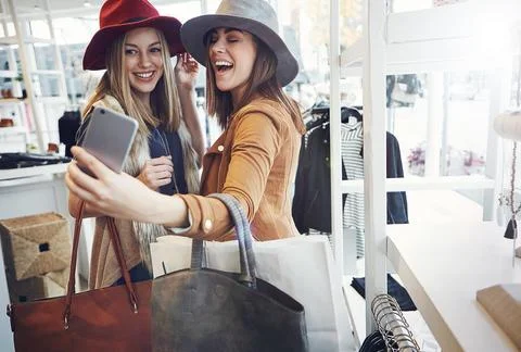 Why would you do anything else. two young girlfriends snapping selfies while out Stock Photos