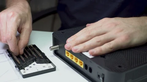 Wi-Fi Modem Electronic Device Repairment with Micro Screwdriver Stock Footage 129423279