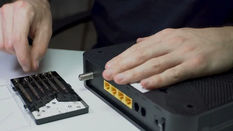 Wi-Fi Modem Electronic Device Repairment with Micro Screwdriver Stock Footage 129528901