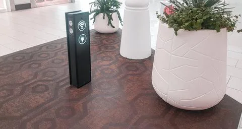 Wi-Fi zone with a rack for charging gadgets via usb and at the airport or sup Stock Photos