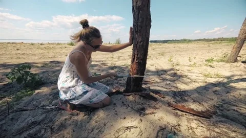 Wicked girl, chills her fervor about a dried tree. Slow motion Stock Footage