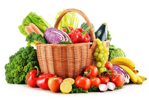 Wicker basket with assorted organic vegetables and fruits  isolated on white Stock Photos