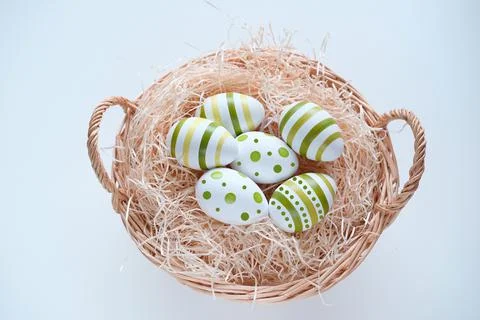 Wicker basket with colored easter egg with painted pattern, concept of Christ Stock Photos