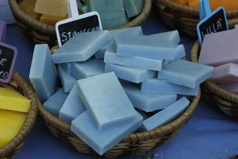 Wicker basket containing pieces of solid blue soap Stock Photos