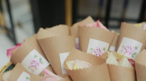 Wicker basket containing small paper containers full of roses. Stock Footage 66443285