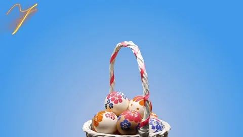 A wicker basket with Easter eggs. Appears the text "Happy Easter" Stock Footage 74273836