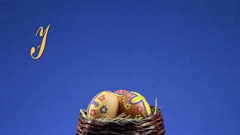 A wicker basket with Easter eggs revolves and appears the text "Happy Easter" 動画素材 74405210