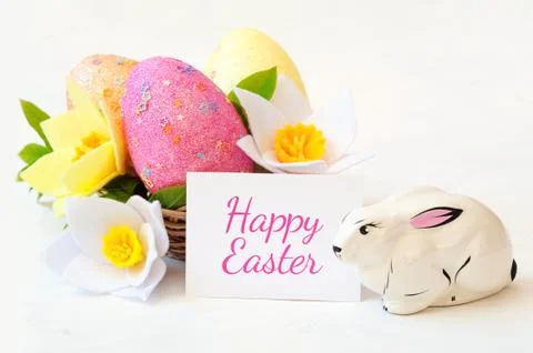 Wicker basket with Easter eggs with spring flower. Stock Photos