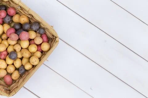 Wicker basket filled with assorted fresh potatoes Stock Photos