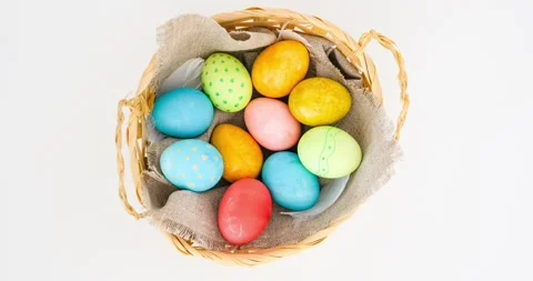 A wicker basket filled with colorful Easter eggs. Looped stop motion animation Stock Footage 331505418