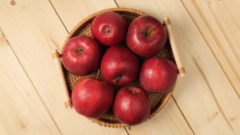 Wicker basket of fresh red apples rotating Stock Footage 340159388