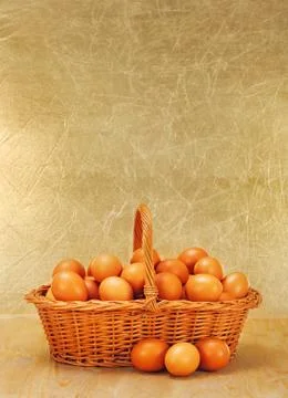 Wicker basket full of eggs Stock Photos