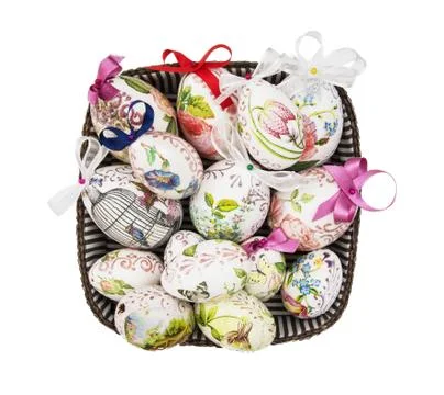 Wicker basket full of painted Easter eggs Stock Photos