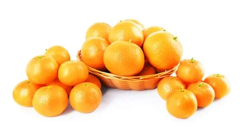 Wicker basket full of tangerines surrounded by heaps of fresh citrus fruit .. Stock Photos