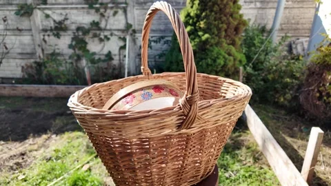 Wicker basket. Large hand-woven basket with handle lies on wooden table. Texture 스톡 동영상 289627678