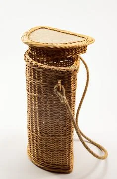 Wicker basket made by the master is placed on the wall Stock Photos