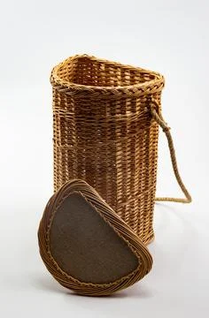 Wicker basket made by the master is placed on the wall Foto stock