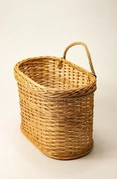 Wicker basket made by the master is placed on the wall Foto stock