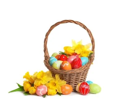Wicker basket with painted Easter eggs and flowers on white background Stock Photos