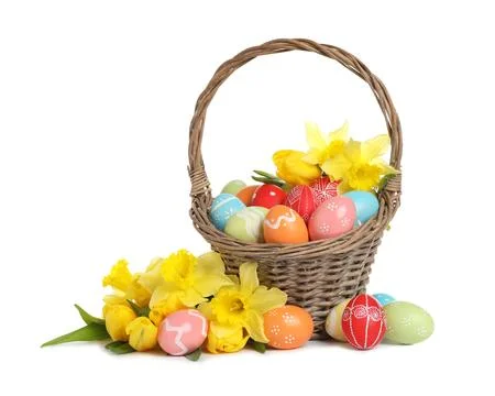 Wicker basket with painted Easter eggs and flowers on white background Stock Photos