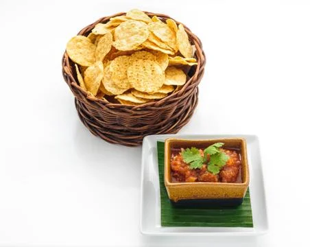 A wicker basket with potatoe chips Stock Photos