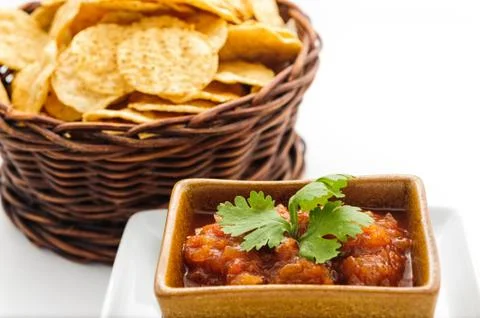 A wicker basket with potatoe chips Stock Photos