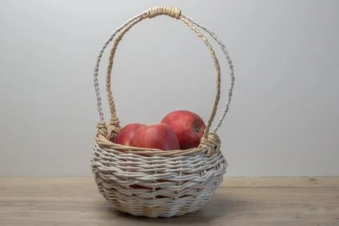 Wicker basket with red apples Stock Photos