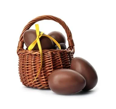 Wicker basket with sweet chocolate Easter eggs on white background Stock Photos