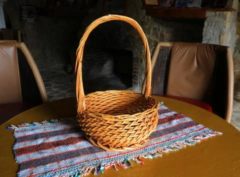 Wicker basket on tablecloth Stock Photos